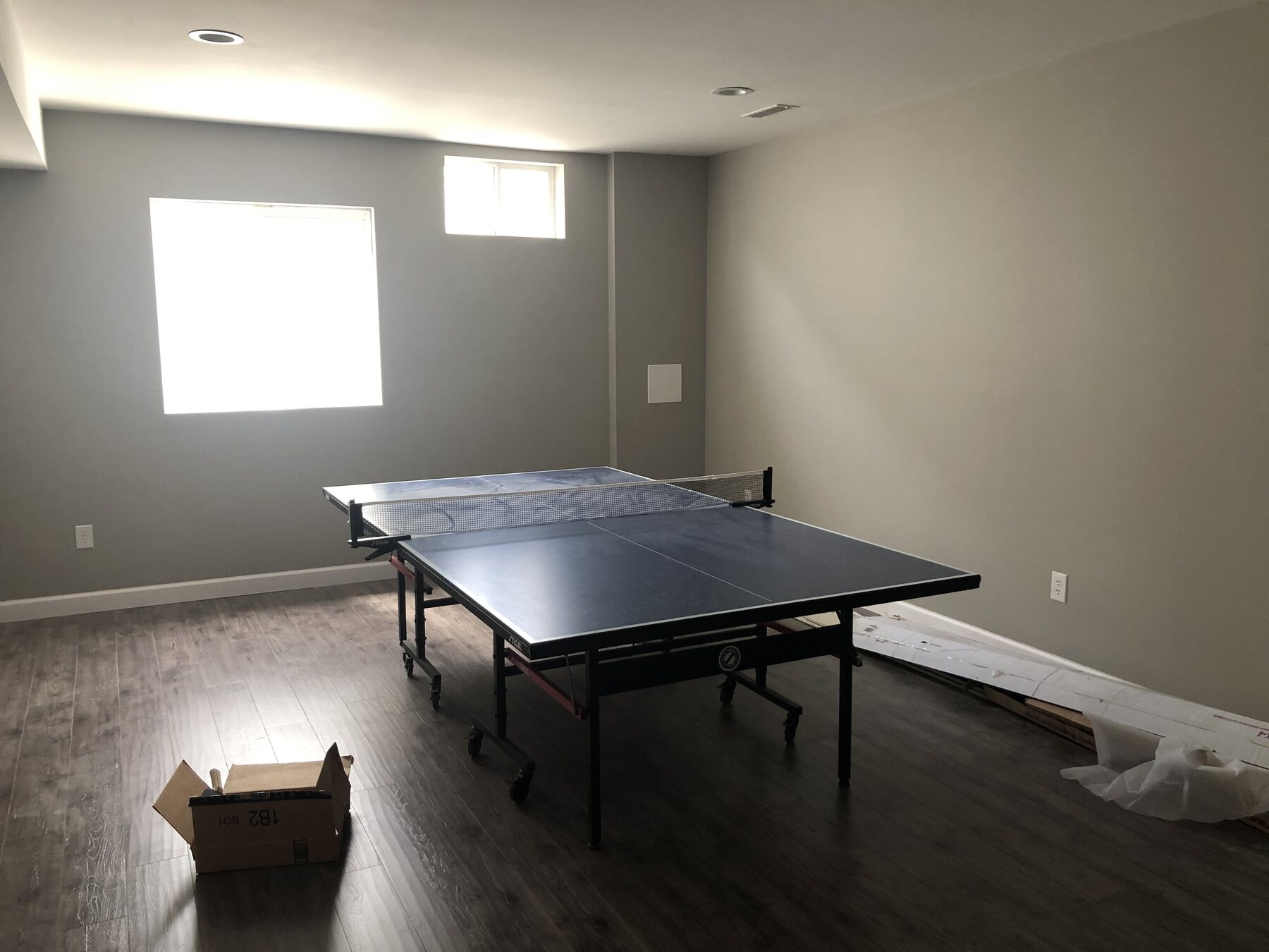 Finished game room with egress windows and LVP flooring